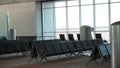 Empty airport terminal lounge. Empty airport seating - typical black chairs in boarding waiting Royalty Free Stock Photo