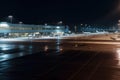 empty airport terminal, with view of parked airplanes and runways, during late night shift