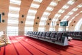 Empty airport terminal waiting area with chairs