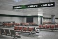 Empty airport waiting room with indications to gates