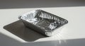 Empty Aluminum Foil Tray with Dramatic Shadows and Reflective Surface Royalty Free Stock Photo