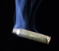 Empty ammunition brass that is smoking Royalty Free Stock Photo