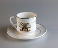 Empty antique porcelain coffee cup with bow on white background Royalty Free Stock Photo