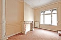 Empty apartment with classical fireplace in perspective