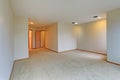 Empty room interior features white walls and beige carpet floor. Royalty Free Stock Photo