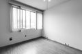 Empty apartment room interior with blank white walls and sliding windows