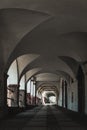 Empty arcade passageway in small town, architecture with arches, vertical format Royalty Free Stock Photo