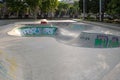 Empty area painted with colored graffiti for skateboarding or rollerblading in the city park