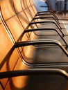 Empty armchairs in an airport lounge zone. Evening light. No people. Vertical photo Royalty Free Stock Photo