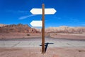 Empty arrow shaped signs in the middle of the desert Royalty Free Stock Photo