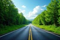 Empty asphalt highway winds through vibrant green forest, fluffy white clouds , white, light, green leaves Royalty Free Stock Photo
