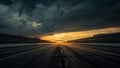 Empty asphalt racetrack stretching towards a brilliant horizon under dramatic stormy clouds just before or after a significant Royalty Free Stock Photo