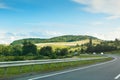 The empty asphalt road and blue sky with white clouds on the sunny day. Classic panorama view of road through fields Royalty Free Stock Photo