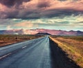 Empty asphalt road with colorful cloudy sky. Royalty Free Stock Photo