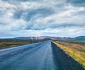 Empty asphalt road with colorful cloudy sky. Beautiful outdoor scenery in the Hverarond geothermal valley, Iceland, Europe. Travel Royalty Free Stock Photo