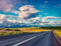 Empty asphalt road with colorful cloudy sky. Royalty Free Stock Photo