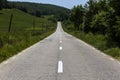 Empty asphalt road in countryside, bend of road, field in the ba Royalty Free Stock Photo