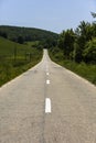 Empty asphalt road in countryside, bend of road, field in the ba Royalty Free Stock Photo