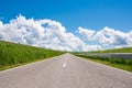 Empty asphalt road , countryside at springime, beautiful blue sky with white clouds Royalty Free Stock Photo