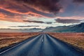 Empty asphalt road with dramatic cloudy sky. Fantastic sunset Iceland. Royalty Free Stock Photo