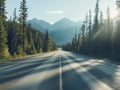 Empty Asphalt Road Through Forest and Mountain Range Royalty Free Stock Photo