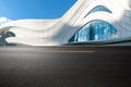 empty asphalt road in front of futuristic modern building