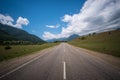 Empty asphalt road highway in the forested mountains, on the background a cloudy sky Royalty Free Stock Photo