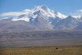 Empty asphalt road leads across the vast plains on the scenic Himalayan Plateau. Royalty Free Stock Photo