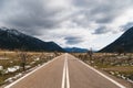 Empty asphalt road in the middle of mountainous area. Highlands of Greece, winter time. Freedom, travel concept. Royalty Free Stock Photo