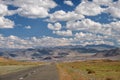 Empty Asphalt road in Mongolia with mongolian town Bayan-Olgii