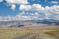 Empty Asphalt road in Mongolia with mongolian town Bayan-Olgii