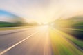 Empty asphalt road in motion blur and sunlight Royalty Free Stock Photo