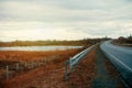 Empty asphalt road with near the lake with cloudy sky in evening light Royalty Free Stock Photo