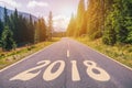 Empty asphalt road and New year 2018 concept. Driving on an empty road in the mountains to upcoming 2018 and leaving behind old 2 Royalty Free Stock Photo