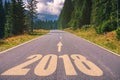 Empty asphalt road and New year 2018 concept. Driving on an empty road in the mountains to upcoming 2018 and leaving behind old 2 Royalty Free Stock Photo