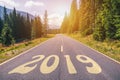 Empty asphalt road and New year 2019 concept. Driving on an empty road in the mountains to upcoming 2019 and leaving behind old 2 Royalty Free Stock Photo