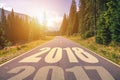 Empty asphalt road and New year 2018 concept. Driving on an empty road in the mountains to upcoming 2018 and leaving behind old 2 Royalty Free Stock Photo