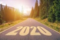 Empty asphalt road and New year 2020 concept. Driving on an empty road in the mountains to upcoming 2020 and leaving behind old Royalty Free Stock Photo