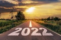 Empty asphalt road and New year 2022 concept. Driving on an empty road to Goals 2022 with sunset Royalty Free Stock Photo