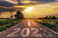 Empty asphalt road and New year 2023 concept. Driving on an empty road to Goals 2023 with sunset