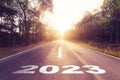 Empty asphalt road and New year 2023 concept. Driving on an empty road to Goals 2023 with sunset Royalty Free Stock Photo