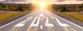 Empty asphalt road and New year 2022 concept. Driving on an empty road to Goals 2022 with sunset. 2022 written on highway road in Royalty Free Stock Photo