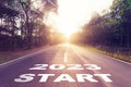 Empty asphalt road and New year 2023 concept. Driving on an empty road to Start 2023 with sunset Royalty Free Stock Photo