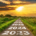 Empty asphalt road and New year 2023 concept. Driving on an empty road to 2023 with sunset Royalty Free Stock Photo