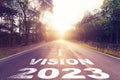 Empty asphalt road and New year 2023 concept. Driving on an empty road to vision 2023 with sunset Royalty Free Stock Photo