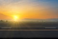 Asphalt road and sky sunset with clouds in the evening with the sunbeam Royalty Free Stock Photo