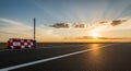 Empty Asphalt Road Stretching Towards the Horizon at Sunset with Dramatic Sun Rays and Clouds highway Royalty Free Stock Photo