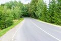 Empty Asphalt winding curve road in a green forest.Landscape with empty asphalt road through woodland in summer day Royalty Free Stock Photo