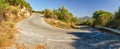 Empty asphalted serpentine mountain road at sunset