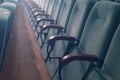 Empty auditorium of cinema or theater. Row of armchairs. Abstract toned background with selective focus Royalty Free Stock Photo